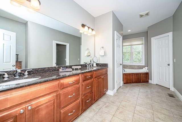 bathroom with a sink, visible vents, and tile patterned floors