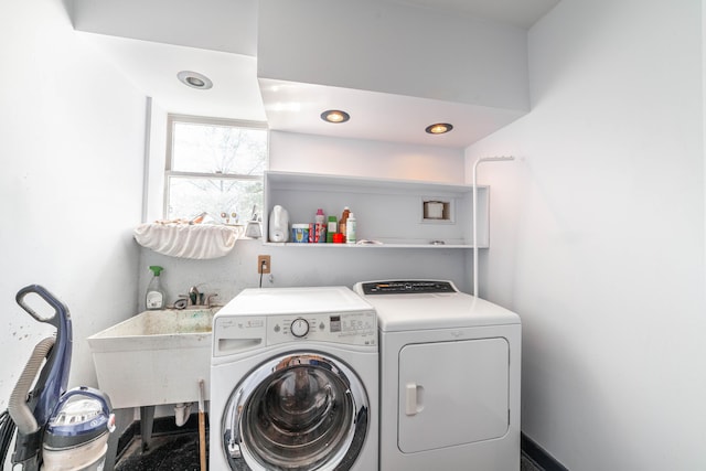 laundry room featuring separate washer and dryer, a sink, and laundry area
