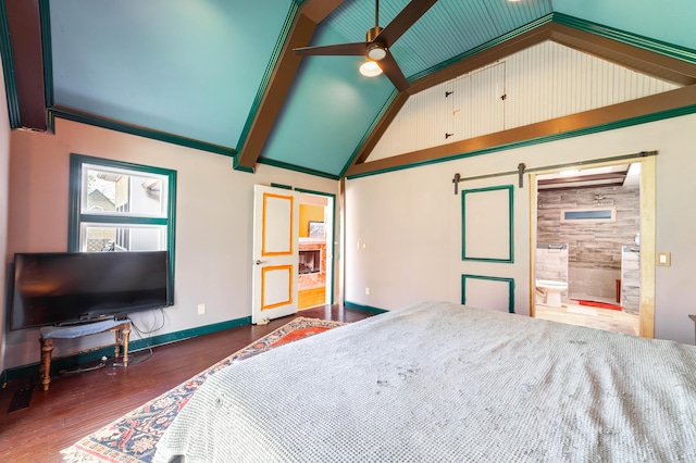bedroom featuring a barn door, ensuite bathroom, baseboards, wood finished floors, and a fireplace