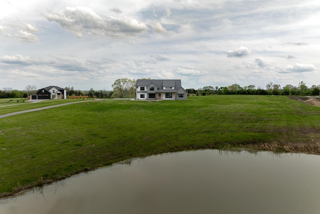 exterior space featuring a rural view, a front yard, and a water view