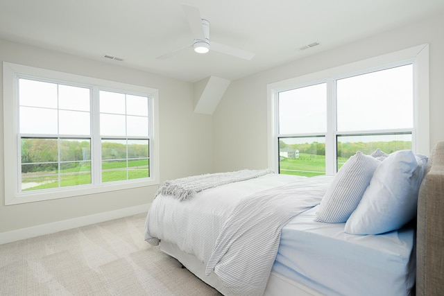 bedroom with visible vents, ceiling fan, light colored carpet, and baseboards