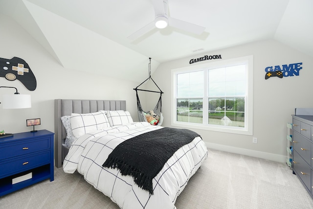 bedroom featuring light colored carpet, a ceiling fan, vaulted ceiling, and baseboards