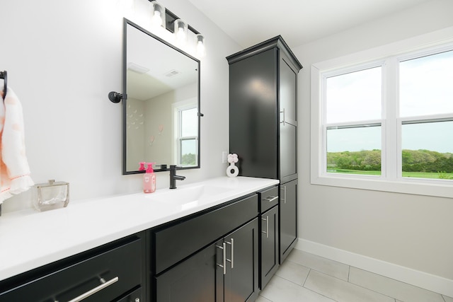 bathroom with tile patterned floors, baseboards, visible vents, and vanity