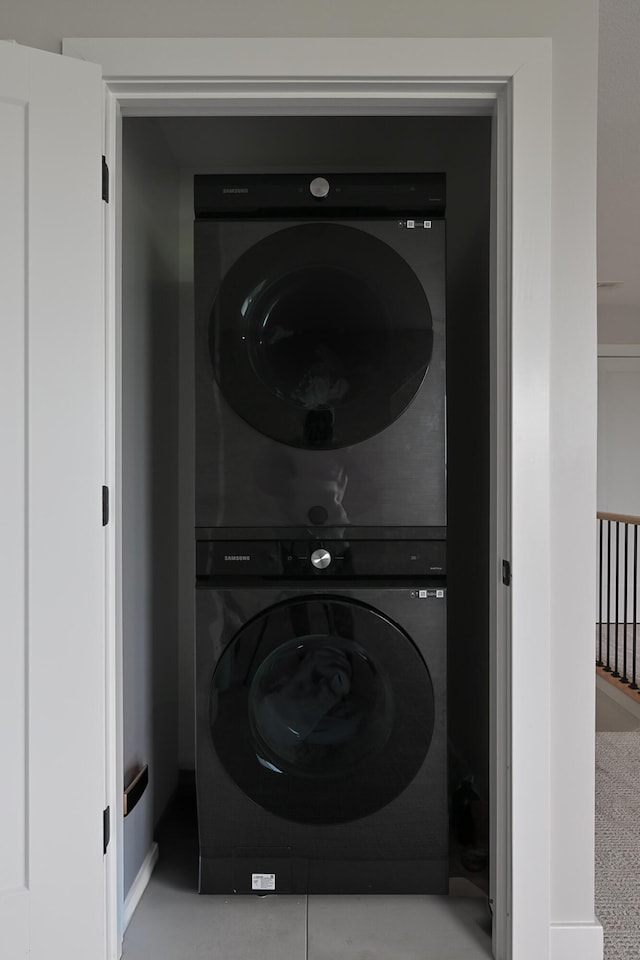 laundry room featuring stacked washer and clothes dryer and laundry area