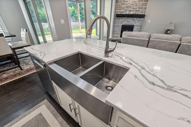 4210 Granite Springs Dr, Columbia, MO 65203 - kitchen with white cabinets, a fireplace, open floor plan, and light stone counters