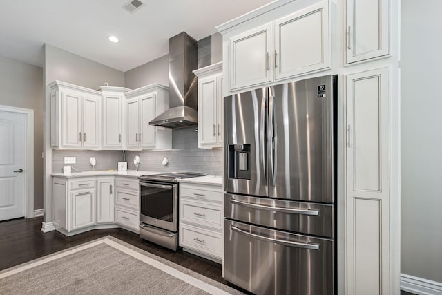4210 Granite Springs Dr, Columbia, MO 65203 - kitchen featuring appliances with stainless steel finishes, wall chimney range hood, backsplash, dark wood finished floors, and white cabinetry