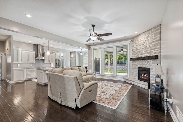 4210 Granite Springs Dr, Columbia, MO 65203 - living area featuring ceiling fan, a stone fireplace, and dark wood-type flooring