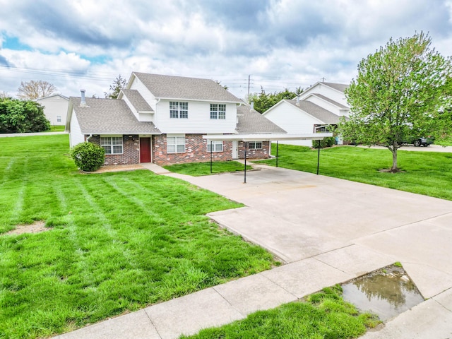 view of front of property featuring brick siding, roof with shingles, and a front yard