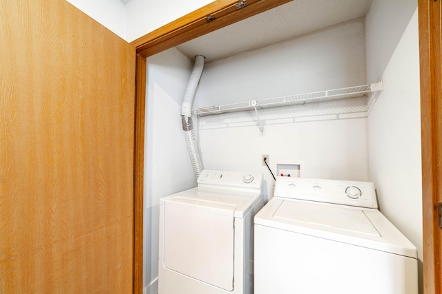 clothes washing area with washing machine and dryer and laundry area