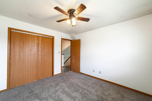 unfurnished bedroom featuring a closet, carpet flooring, baseboards, and ceiling fan
