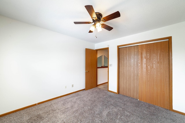 unfurnished bedroom featuring baseboards, a ceiling fan, carpet flooring, and a closet