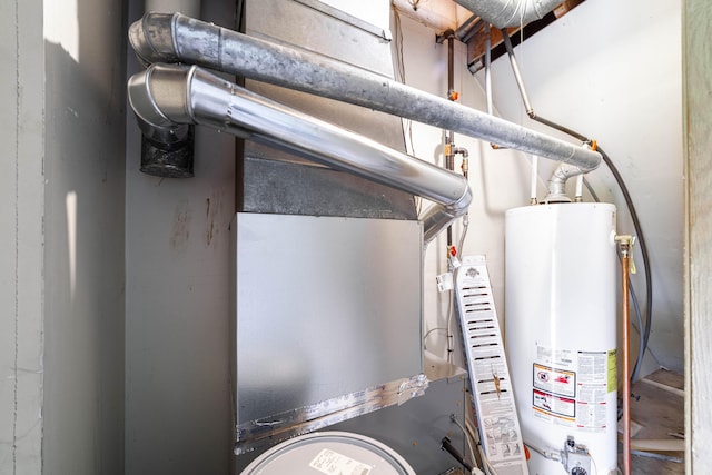 utility room featuring water heater