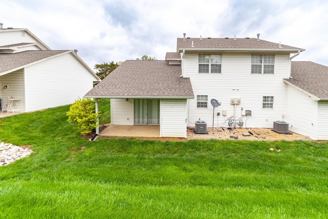 back of house with roof with shingles, a yard, cooling unit, and a patio