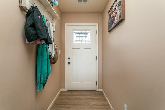 entryway with wood finished floors, visible vents, and baseboards