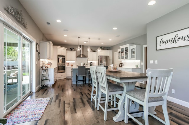 dining space featuring dark wood finished floors, recessed lighting, and visible vents