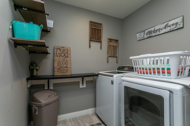 laundry area featuring separate washer and dryer, laundry area, and baseboards