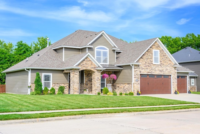 craftsman-style home with a front yard, driveway, and roof with shingles