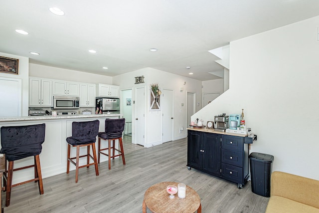 living room featuring recessed lighting and light wood-style flooring