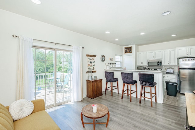 living room with recessed lighting and light wood finished floors
