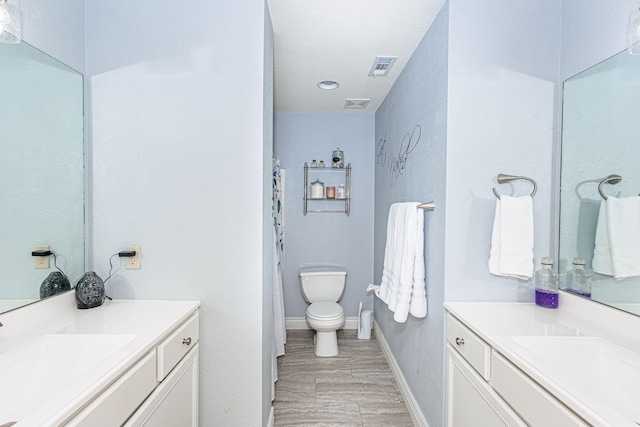 bathroom featuring vanity, baseboards, and visible vents