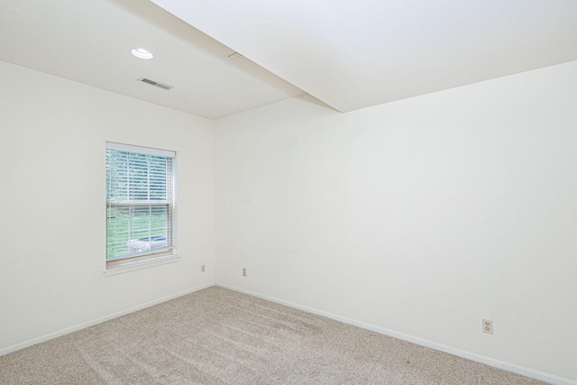 carpeted empty room featuring visible vents, recessed lighting, and baseboards