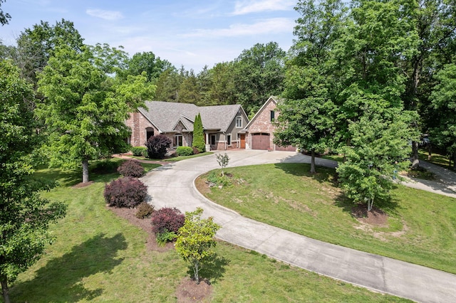 7114 W River Oaks Rd, Columbia, MO 65203 - view of front of property with curved driveway, a front lawn, an attached garage, stone siding, and brick siding