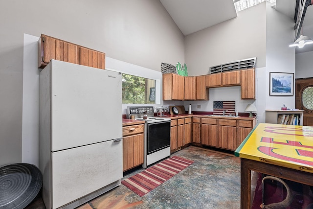 7114 W River Oaks Rd, Columbia, MO 65203 - kitchen with freestanding refrigerator, range with electric stovetop, high vaulted ceiling, concrete floors, and brown cabinets