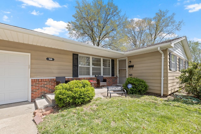 208 Bourn Ave, Columbia, MO 65203 - property entrance with covered porch, brick siding, and a lawn