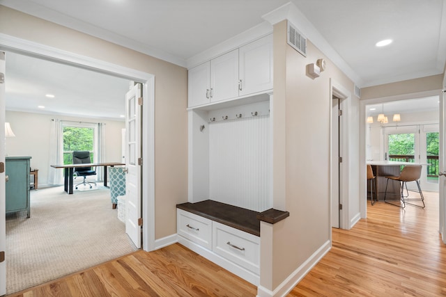 mudroom featuring visible vents, baseboards, and light wood-style floors