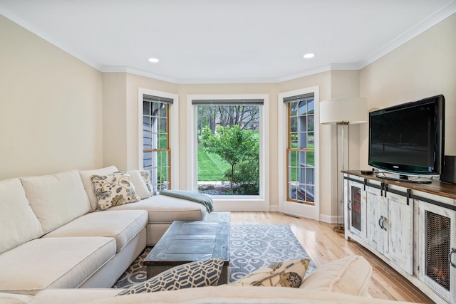 living area with baseboards, recessed lighting, ornamental molding, and light wood-style flooring