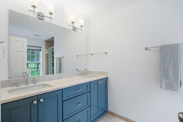 full bathroom featuring tile patterned floors, a shower stall, double vanity, and a sink