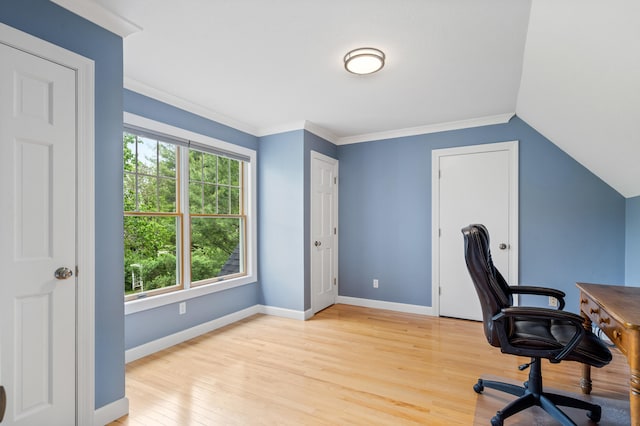 unfurnished office with light wood-style floors, crown molding, and baseboards