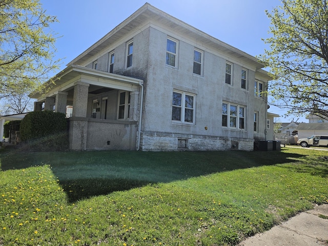 view of home's exterior featuring a lawn and stucco siding