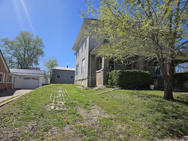 view of home's exterior with a yard and an attached garage