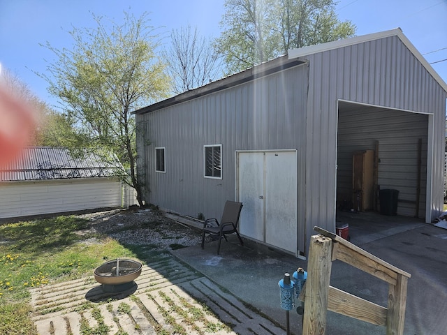 view of outbuilding featuring an outbuilding and a fire pit