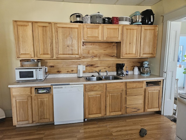 kitchen featuring dark wood-style flooring, white appliances, light countertops, and a sink