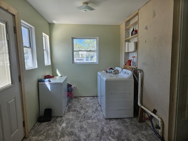 laundry area featuring a healthy amount of sunlight, laundry area, and washing machine and dryer