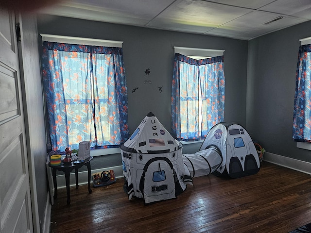 rec room featuring visible vents, hardwood / wood-style flooring, and baseboards