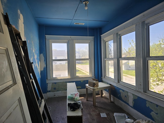 interior space featuring wood finished floors, visible vents, and baseboards