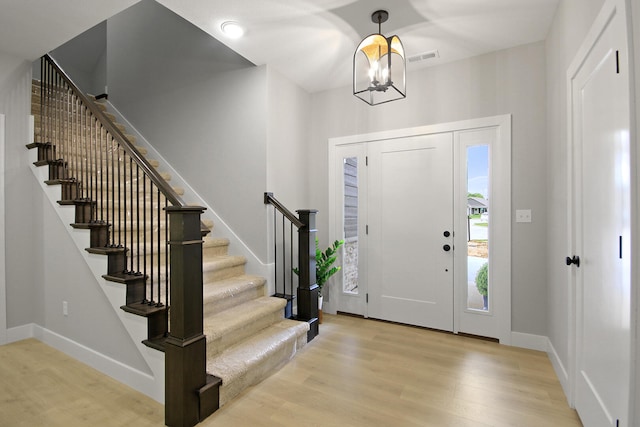 6176 Partridge Ct, Columbia, MO 65202 - entrance foyer featuring stairs, wood finished floors, and a chandelier