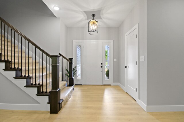 6176 Partridge Ct, Columbia, MO 65202 - entryway with wood finished floors, stairs, and a chandelier