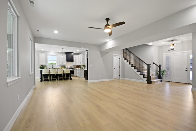 6176 Partridge Ct, Columbia, MO 65202 - living room featuring stairway, light wood-style floors, ceiling fan, and recessed lighting