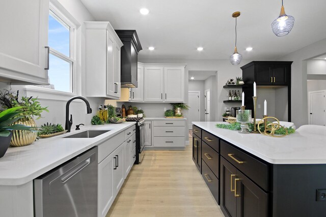 6176 Partridge Ct, Columbia, MO 65202 - kitchen with stainless steel dishwasher, gas range oven, light wood finished floors, a kitchen island, and pendant lighting
