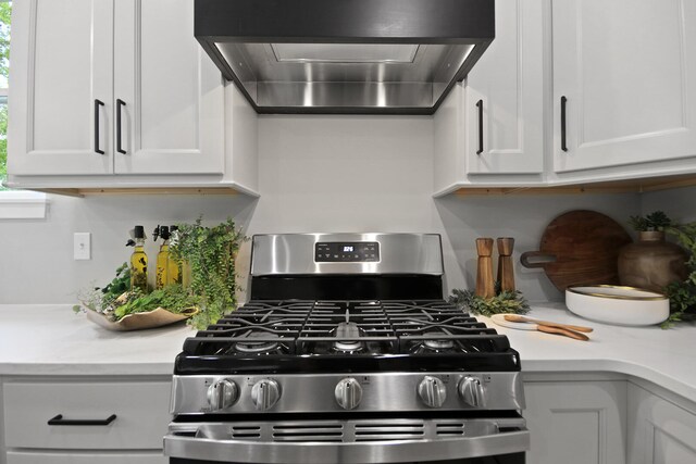 6176 Partridge Ct, Columbia, MO 65202 - kitchen with gas range, range hood, light countertops, and white cabinets