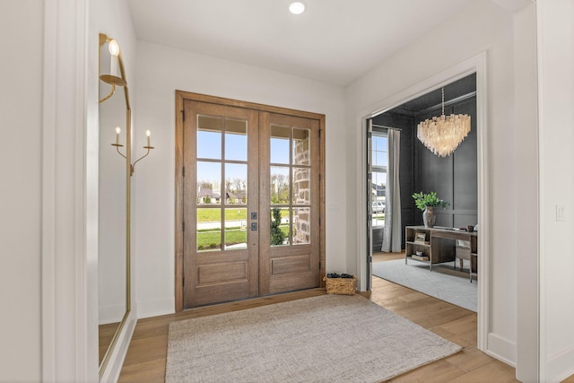 entryway featuring french doors, recessed lighting, light wood-style flooring, and baseboards