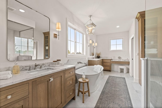 bathroom featuring tile patterned floors, a chandelier, visible vents, a freestanding tub, and vanity