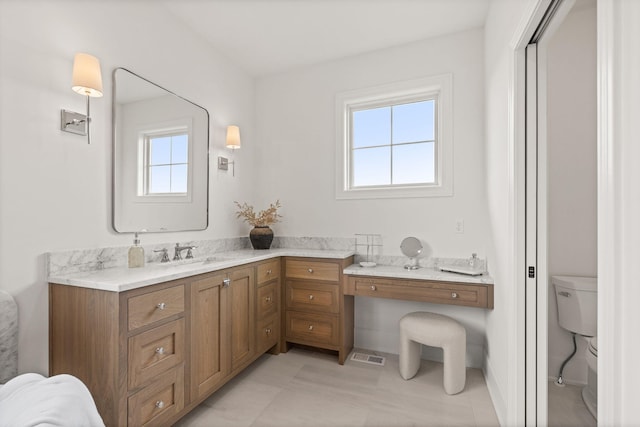 bathroom featuring tile patterned floors, vanity, and toilet