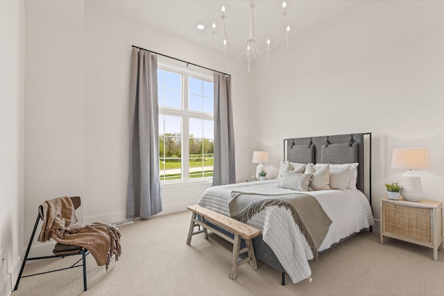 bedroom featuring an inviting chandelier, light carpet, and baseboards