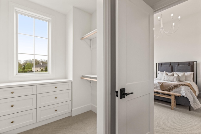 bedroom with multiple windows, light colored carpet, and baseboards