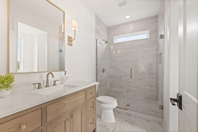 bathroom with marble finish floor, toilet, vanity, visible vents, and a stall shower